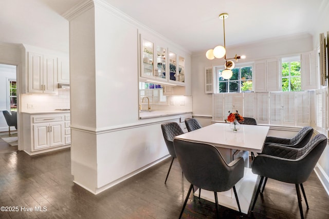 1714 E Walnut St, Goldsboro, NC 27530 - dining space featuring crown molding and dark wood-style floors