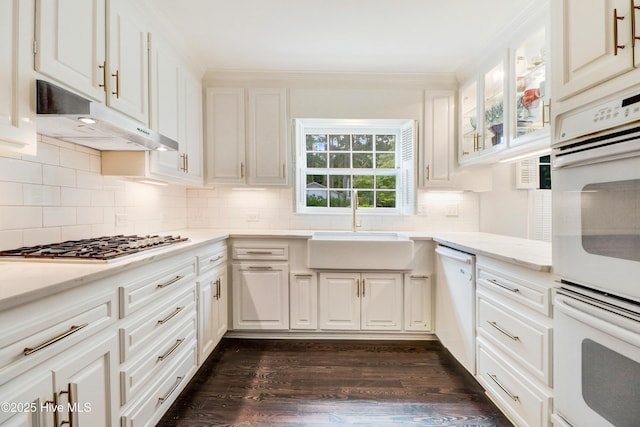 1714 E Walnut St, Goldsboro, NC 27530 - kitchen featuring white appliances, under cabinet range hood, backsplash, dark wood-style flooring, and white cabinets