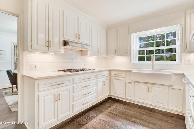 1714 E Walnut St, Goldsboro, NC 27530 - kitchen with under cabinet range hood, crown molding, gas stovetop, dark wood-type flooring, and white cabinets