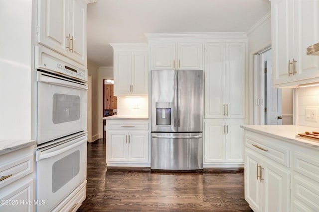 1714 E Walnut St, Goldsboro, NC 27530 - kitchen with stainless steel refrigerator with ice dispenser, white double oven, crown molding, dark wood-style floors, and white cabinetry