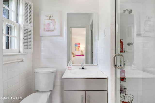 1714 E Walnut St, Goldsboro, NC 27530 - full bath featuring vanity, a stall shower, and tile walls