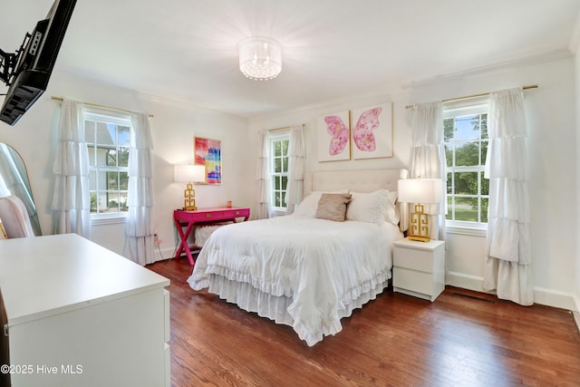 1714 E Walnut St, Goldsboro, NC 27530 - bedroom with multiple windows, dark wood-style floors, a chandelier, and ornamental molding