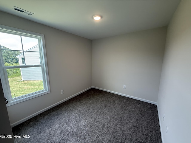 37 Chloe Ct, Selma, NC 27576 - spare room with dark colored carpet and baseboards