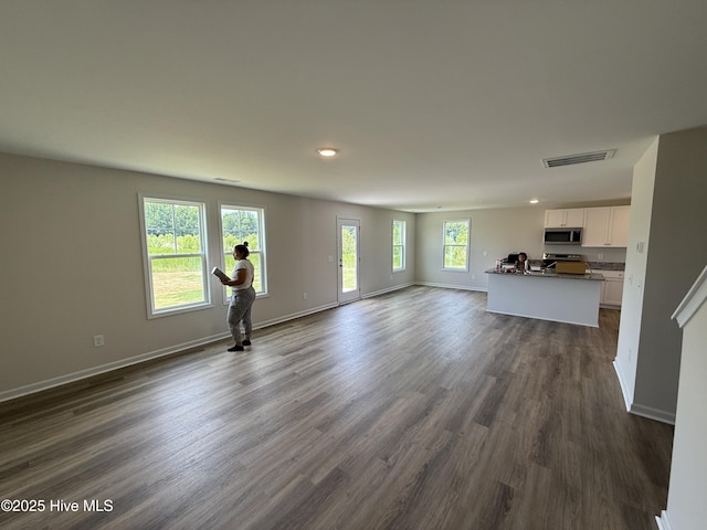 37 Chloe Ct, Selma, NC 27576 - unfurnished living room featuring dark wood-style flooring and recessed lighting