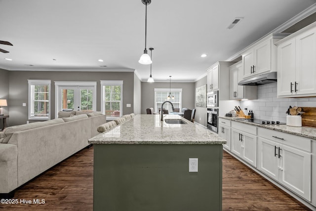 28 Winding Trl, Whispering Pines, NC 28327 - kitchen with appliances with stainless steel finishes, open floor plan, dark wood-type flooring, ornamental molding, and decorative backsplash