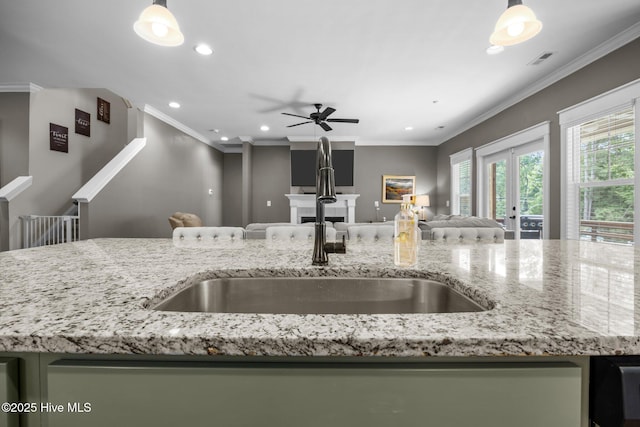 28 Winding Trl, Whispering Pines, NC 28327 - kitchen with open floor plan, recessed lighting, a ceiling fan, light stone countertops, and hanging light fixtures