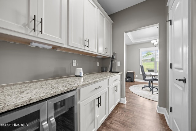 28 Winding Trl, Whispering Pines, NC 28327 - bar area featuring beverage cooler, dark wood-style floors, and a chandelier