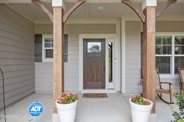 28 Winding Trl, Whispering Pines, NC 28327 - doorway to property featuring covered porch