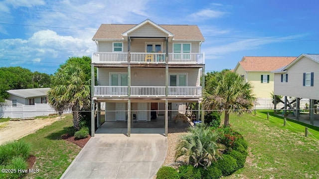 110 Mangrove Blvd, Emerald Isle, NC 28594 - beach home with driveway, a balcony, and french doors