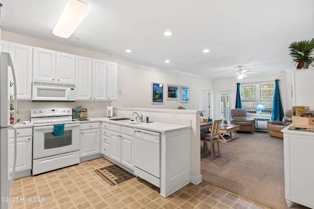 235 Woodlands Way Unit 9, Calabash, NC 28467 - kitchen with white appliances, a peninsula, open floor plan, white cabinets, and ceiling fan