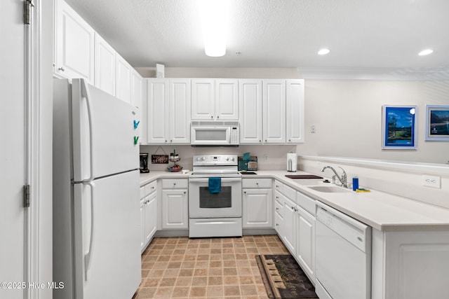 235 Woodlands Way Unit 9, Calabash, NC 28467 - kitchen with white appliances, white cabinets, light countertops, recessed lighting, and a peninsula