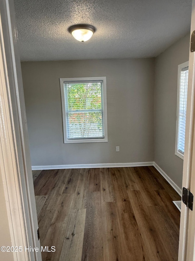1415 Glenn St, Wilmington, NC 28401 - unfurnished room featuring dark wood-style flooring and a textured ceiling