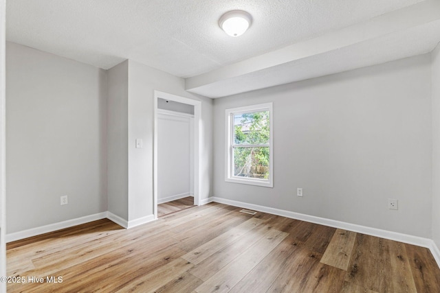 1415 Glenn St, Wilmington, NC 28401 - unfurnished bedroom featuring hardwood / wood-style flooring, a closet, and a textured ceiling