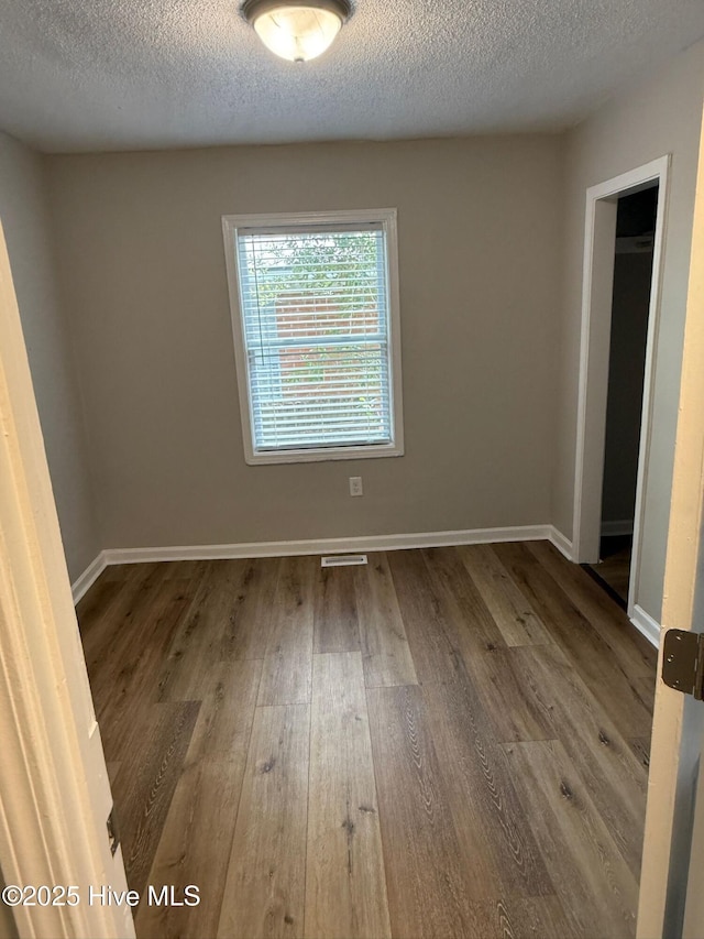 1415 Glenn St, Wilmington, NC 28401 - spare room with wood finished floors and a textured ceiling
