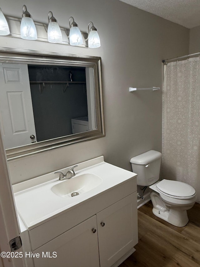 1415 Glenn St, Wilmington, NC 28401 - bathroom featuring wood finished floors, vanity, and a textured ceiling