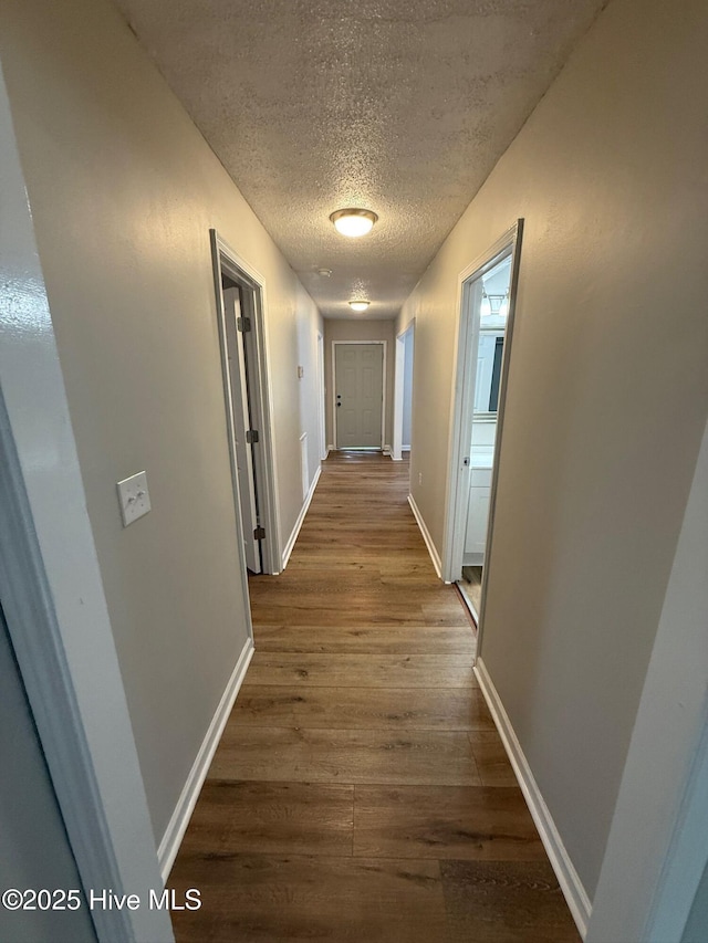 1415 Glenn St, Wilmington, NC 28401 - corridor featuring a textured ceiling and dark wood finished floors