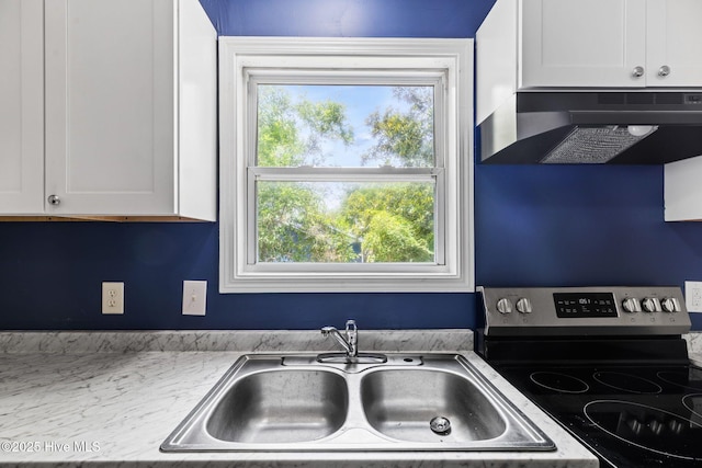 1415 Glenn St, Wilmington, NC 28401 - kitchen with electric stove, under cabinet range hood, and white cabinets