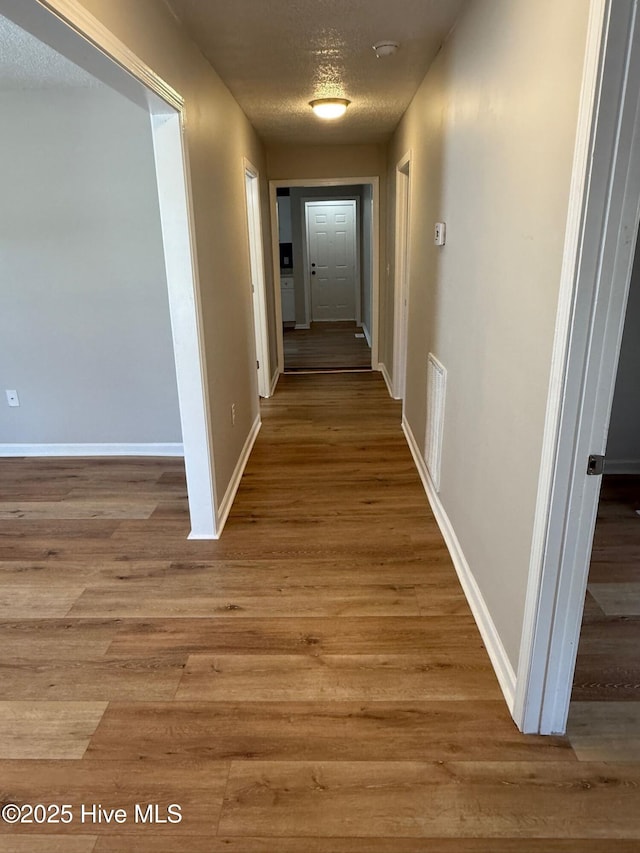1415 Glenn St, Wilmington, NC 28401 - corridor with a textured ceiling and light wood-style flooring