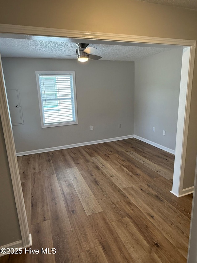 1415 Glenn St, Wilmington, NC 28401 - unfurnished room featuring a textured ceiling, dark wood finished floors, and a ceiling fan