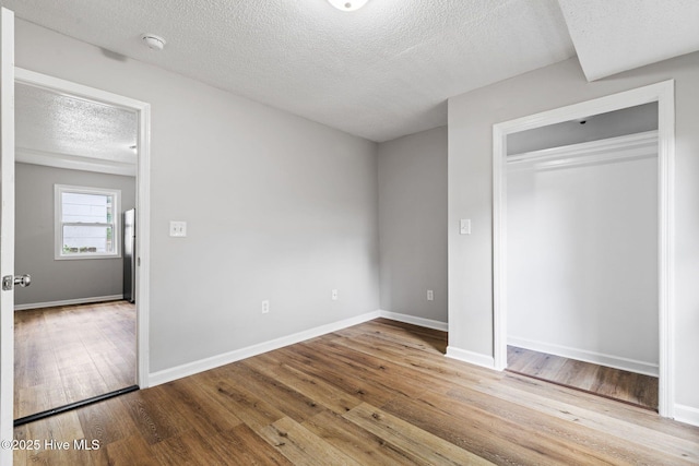 1415 Glenn St, Wilmington, NC 28401 - unfurnished bedroom with a textured ceiling, wood finished floors, and a closet