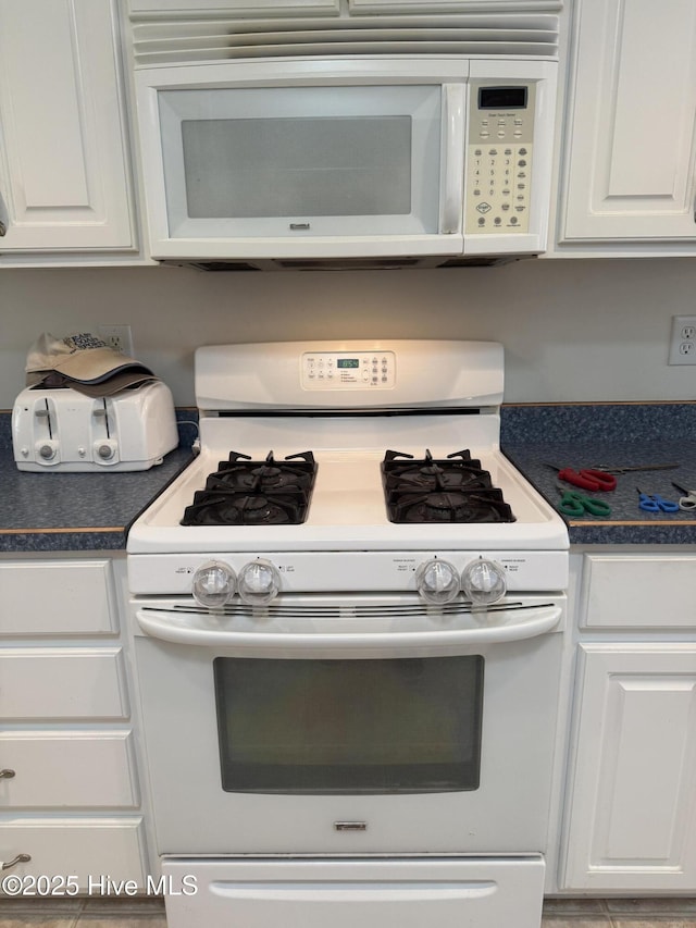 208 Canterwood Ln, New Bern, NC 28562 - kitchen featuring white appliances, white cabinets, and dark countertops