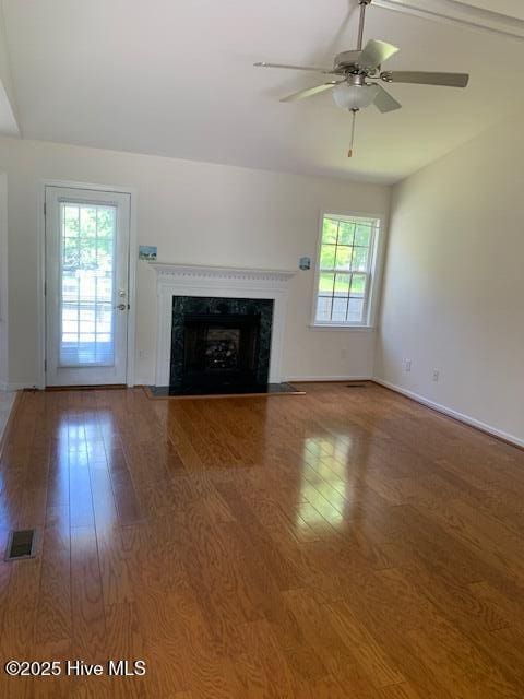208 Canterwood Ln, New Bern, NC 28562 - unfurnished living room with wood finished floors, a fireplace, and a ceiling fan