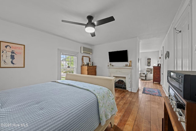 409 Hancock St, New Bern, NC 28560 - bedroom featuring a wall mounted air conditioner, hardwood / wood-style flooring, a fireplace, and ceiling fan