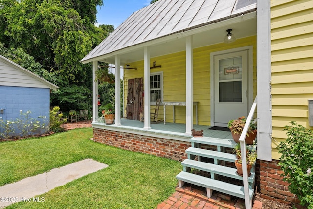 409 Hancock St, New Bern, NC 28560 - doorway to property featuring a porch, a standing seam roof, a yard, and a metal roof