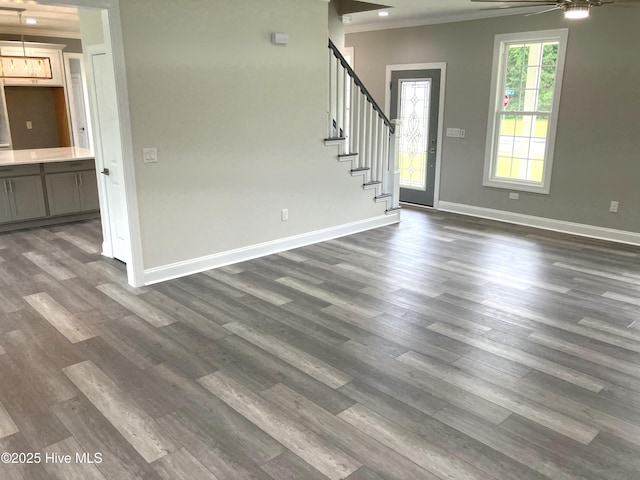 407 King Richard Ct, Jacksonville, NC 28546 - unfurnished living room featuring crown molding, stairway, dark wood finished floors, and a ceiling fan