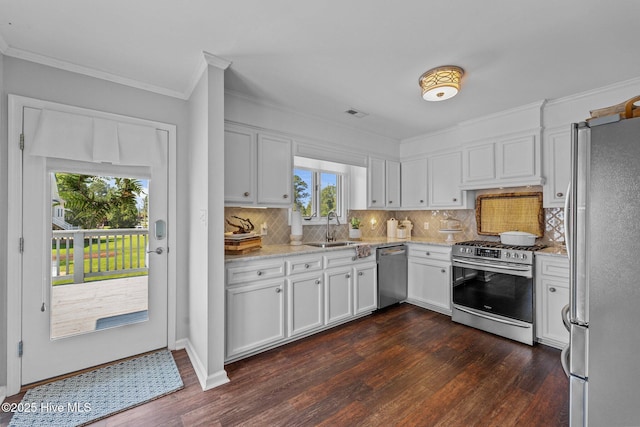 938 E Bayside Dr, Chocowinity, NC 27817 - kitchen with appliances with stainless steel finishes, crown molding, dark wood-style flooring, and white cabinets