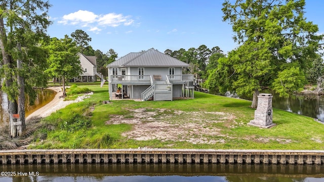 938 E Bayside Dr, Chocowinity, NC 27817 - back of house featuring stairs, a deck with water view, a lawn, and a metal roof