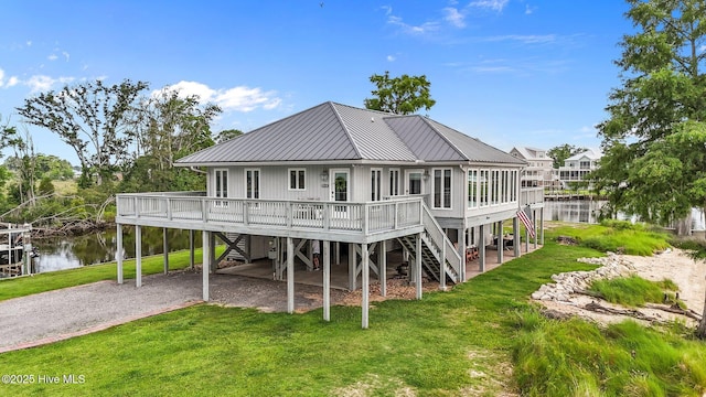 938 E Bayside Dr, Chocowinity, NC 27817 - back of property featuring stairs, driveway, a yard, a metal roof, and a deck with water view