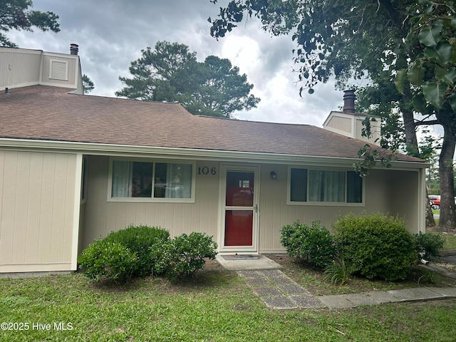 106 Quarterdeck Townes Townes Unit 106, New Bern, NC 28562 - view of front of house featuring a chimney and roof with shingles