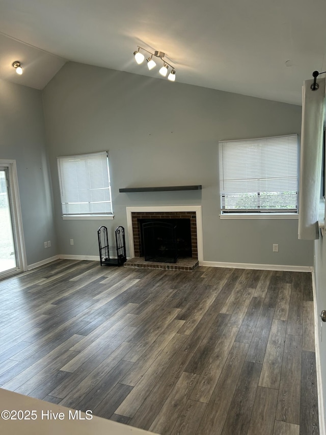 106 Quarterdeck Townes Townes Unit 106, New Bern, NC 28562 - unfurnished living room with vaulted ceiling, wood finished floors, a fireplace, and healthy amount of natural light