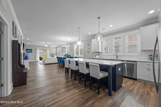 184 Twining Rose Ln, Holly Ridge, NC 28445 - kitchen featuring stainless steel dishwasher, a kitchen island, open floor plan, dark wood-style flooring, and crown molding