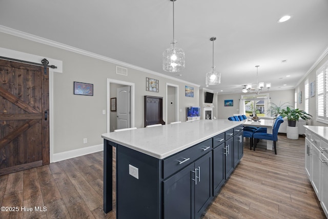 184 Twining Rose Ln, Holly Ridge, NC 28445 - kitchen with ornamental molding, dark wood-style floors, recessed lighting, a kitchen island, and open floor plan