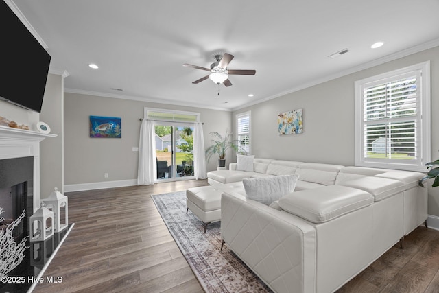 184 Twining Rose Ln, Holly Ridge, NC 28445 - living room with ceiling fan, dark wood finished floors, crown molding, a fireplace, and recessed lighting