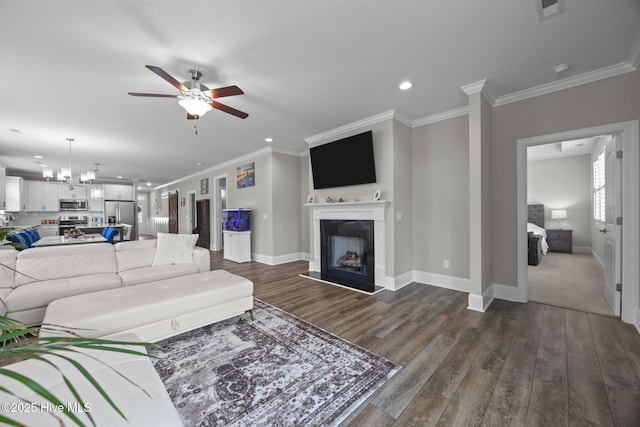 184 Twining Rose Ln, Holly Ridge, NC 28445 - living room featuring ceiling fan, dark wood-style flooring, a fireplace with raised hearth, ornamental molding, and recessed lighting