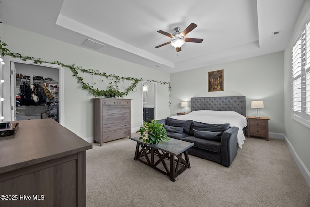 184 Twining Rose Ln, Holly Ridge, NC 28445 - bedroom with a raised ceiling, a walk in closet, light carpet, and a closet