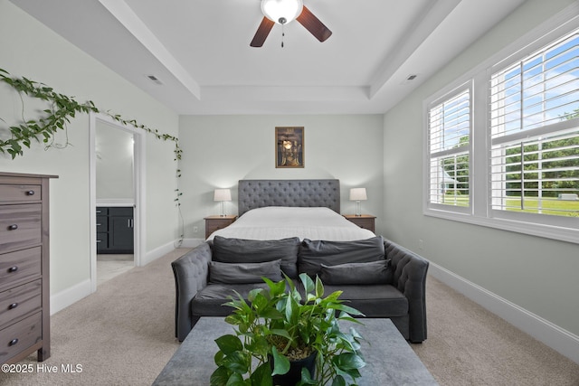 184 Twining Rose Ln, Holly Ridge, NC 28445 - bedroom featuring a raised ceiling, light carpet, connected bathroom, and ceiling fan