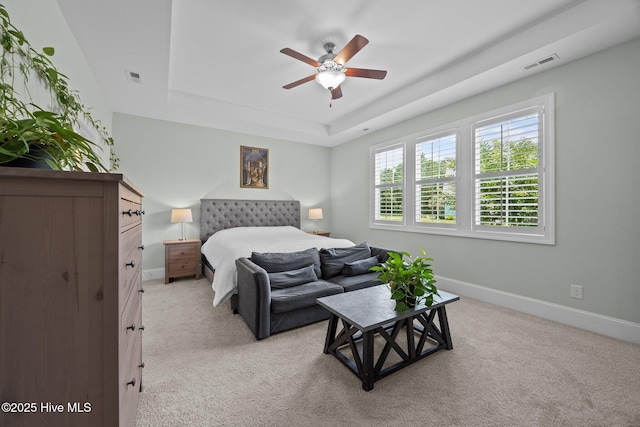 184 Twining Rose Ln, Holly Ridge, NC 28445 - bedroom with a tray ceiling, light carpet, and a ceiling fan