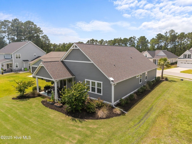 184 Twining Rose Ln, Holly Ridge, NC 28445 - back of property featuring a lawn, a residential view, roof with shingles, and a patio