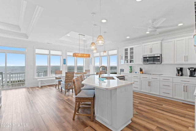 328 E First St, Ocean Isle Beach, NC 28469 - kitchen featuring stainless steel microwave, crown molding, healthy amount of natural light, recessed lighting, and black electric stovetop