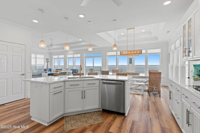 328 E First St, Ocean Isle Beach, NC 28469 - kitchen featuring stainless steel dishwasher, a tray ceiling, ornamental molding, light countertops, and healthy amount of natural light