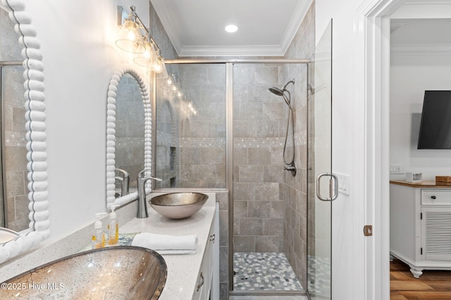 328 E First St, Ocean Isle Beach, NC 28469 - bathroom with crown molding, double vanity, a stall shower, wood finished floors, and recessed lighting
