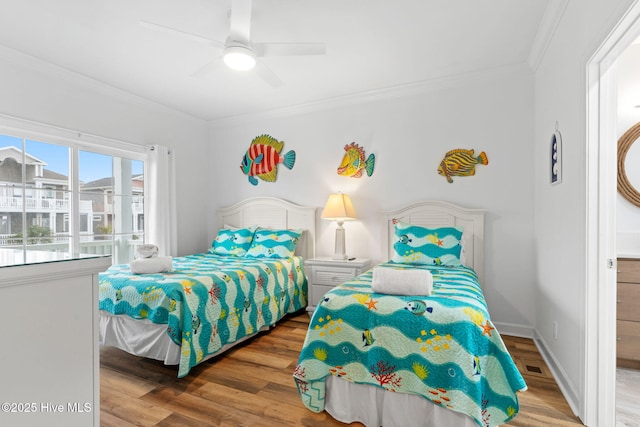 328 E First St, Ocean Isle Beach, NC 28469 - bedroom with ornamental molding, wood finished floors, and a ceiling fan