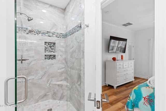 328 E First St, Ocean Isle Beach, NC 28469 - bathroom featuring a marble finish shower, ornamental molding, and wood finished floors
