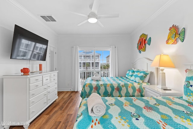 328 E First St, Ocean Isle Beach, NC 28469 - bedroom featuring access to exterior, wood finished floors, ornamental molding, and ceiling fan