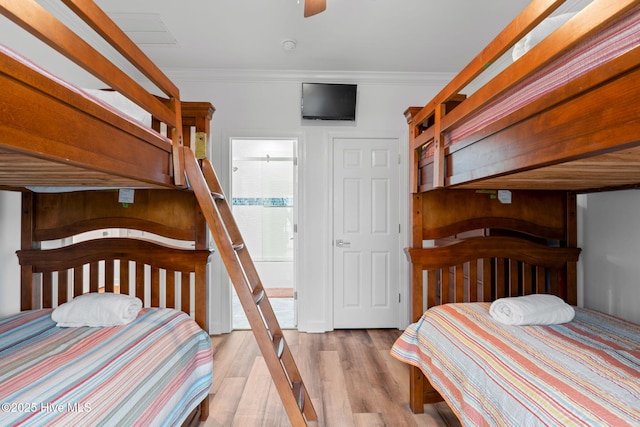 328 E First St, Ocean Isle Beach, NC 28469 - bedroom featuring ornamental molding and wood finished floors