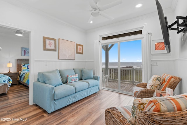 328 E First St, Ocean Isle Beach, NC 28469 - living room with ornamental molding, ceiling fan, wood finished floors, a wainscoted wall, and recessed lighting
